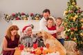 Parents and kids celebrating Christmas with pet Royalty Free Stock Photo