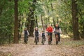 Parents and kids cycling on forest trail. Young family cycling in autumn park. Family mountain biking on forest. Theme family Royalty Free Stock Photo