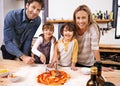 Parents, kids and portrait for cooking pizza with sauce, learning or helping hand for development in kitchen. Mother Royalty Free Stock Photo