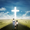 Parents and kids on the road with a cross Royalty Free Stock Photo