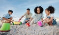 Parents, kids and sandcastle at beach, bucket and digging for bonding, outdoor and vacation in summer. Mom, dad and Royalty Free Stock Photo