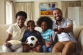 Parents and kids watching television in living room Royalty Free Stock Photo