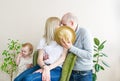 Parents kiss, having hidden for a big straw hat. Little daughter stand nearby Royalty Free Stock Photo