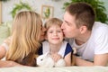 parents kiss his beautiful daughter