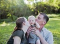 Parents kissing baby Royalty Free Stock Photo