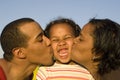 Parents kissing daughter Royalty Free Stock Photo