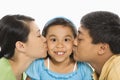 Parents kissing daughter. Royalty Free Stock Photo