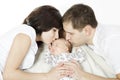 Parents kissing newborn baby