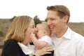 Parents kissing their baby Royalty Free Stock Photo