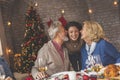 Parents kissing their daughter during Christmas dinner Royalty Free Stock Photo