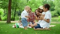 Parents laughing together with kids outdoors. Family spending weekend in forest Royalty Free Stock Photo