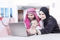 Parents and little boy looking at laptop