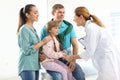 Parents with little daughter visiting children`s doctor