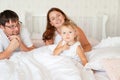 Parents look at little girl sleep in bed in bedroom with crown.Princess birthday Royalty Free Stock Photo