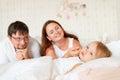 Parents look at little girl sleep in bed in bedroom with crown.Princess birthday Royalty Free Stock Photo