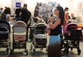 Parents looking at baby carriages