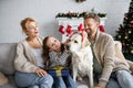 Parents looking at daughter with present