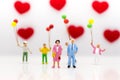 Parents love each other happily, with children playing balloons are behind, used as a wedding anniversary concept Royalty Free Stock Photo