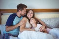 Parents lying on bed with daughter Royalty Free Stock Photo