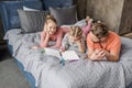 Parents lying on bed and looking at smiling daughter drawing Royalty Free Stock Photo