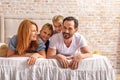 Parents lying in bedroom with kids Royalty Free Stock Photo