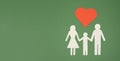 Parents with one child holding hands, paper cut out, heart over the family, copy space for text Royalty Free Stock Photo