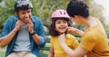 Parents, park bench and helmet with child, help and safety for skating, rollerskate or bike. Interracial parents, mom