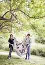 Parents playing with child in blanket