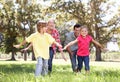 Parents playing with children in country