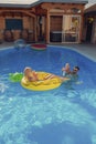 Parents playing with daughter at the swimming pool Royalty Free Stock Photo