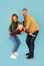 Parents Playing With Little Daughter Holding Her In Arms, Studio