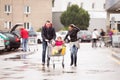 Parents pushing shopping cart with groceries and their daughters Royalty Free Stock Photo