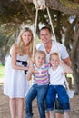 Parents pushing their children on a swing Royalty Free Stock Photo