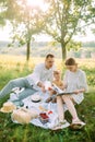 Parents read a book to their daughter in the park