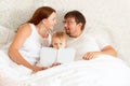 Parents reading book to daughter in bed. place for text on white paper.