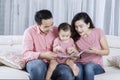 Parents reading story tale with their baby