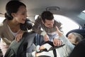 Parents securing baby in the car seat Royalty Free Stock Photo