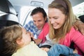 Parents securing baby in the car seat Royalty Free Stock Photo