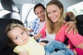 Parents securing baby in the car seat Royalty Free Stock Photo