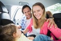 Parents securing baby in the car seat Royalty Free Stock Photo