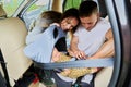 Parents is securing his baby within car seat harness. Royalty Free Stock Photo