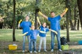 Parents showing success gesture, and children