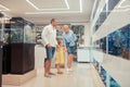 Parents showing their little girl fishes while visiting aquarium Royalty Free Stock Photo