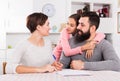 Parents signing property papers Royalty Free Stock Photo