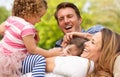 Parents Sitting With Children In Field Royalty Free Stock Photo