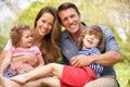 Parents Sitting With Children In Field Royalty Free Stock Photo