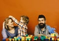 Parents and son with happy faces make brick constructions. Love and family games. Young family spends time in playroom Royalty Free Stock Photo