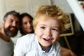 Parents and son with proud and happy faces play together