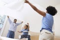 Parents Spreading Bedsheet Over Son