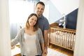 The Parents standing In Nursery With Baby son